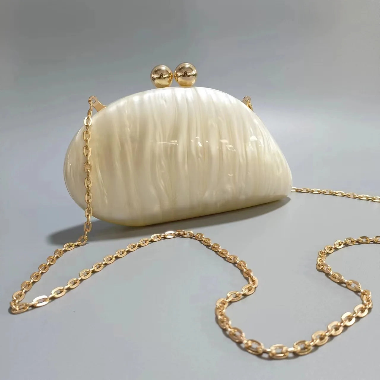 Blue acrylic shell-shaped clutch bag for women, designer evening party purse with pearl accents, stylish and cute for special occasions.