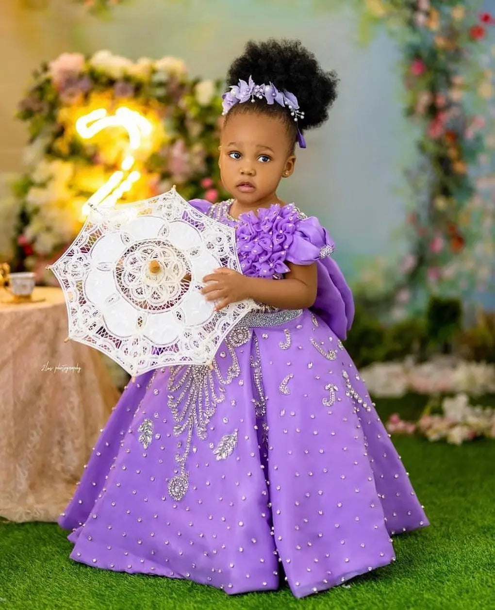 Lavender beaded queen ball gown for girls with intricate details, luxurious fabric, and elegant design, perfect for special occasions.