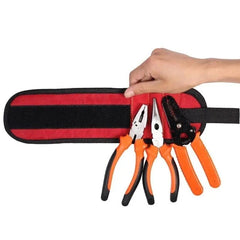 A red and black magnetic wristband holding three pairs of pliers against a white background.