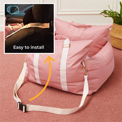 A pink waterproof pet car seat bed with white straps and an inset showing how it attaches to a seat.