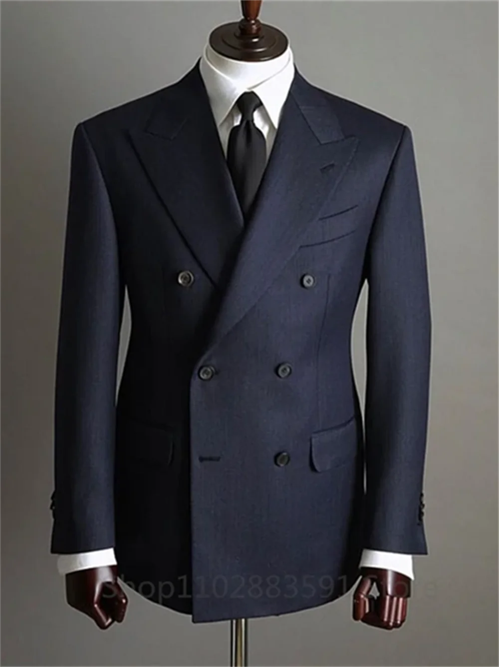 Two-piece men's tuxedo blazer and pants set with double-breasted buttons and peaked lapel, suitable for formal parties and weddings.