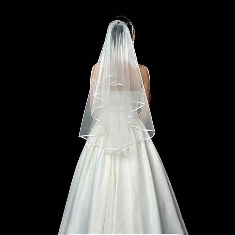 White two-layer tulle wedding veil with comb, shoulder length, for brides, featuring elegant and simple bridal accessory design.