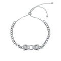 Silver and gold-tone Cuban link bracelet featuring double jaguar head charms with black and white CZ stones, adjustable for women.