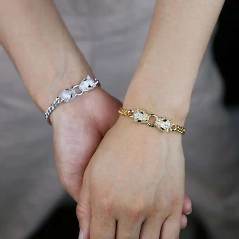 Silver and gold-tone Showlu Store Nation Jaguar Head Cuban Link bracelet with CZ stones, adjustable for women.