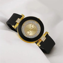 A black silicone strap watch with a gold-tone round dial featuring a glittery border and D&G logo.