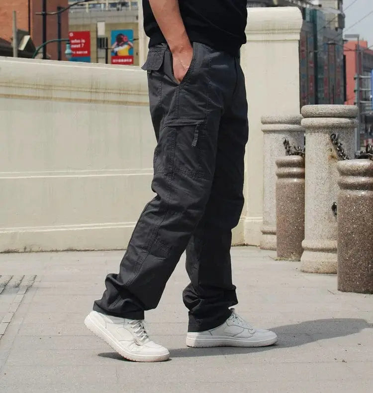 Showlu Fashion men's 100% cotton casual outdoor pants with multiple pockets and elastic waist, suitable for spring outdoor activities.