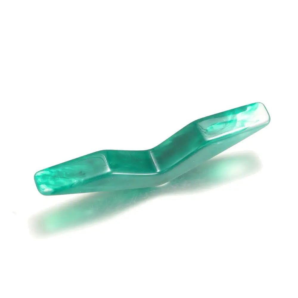 Acrylic thumb book page holder in geometric design, supports and holds book pages for easy reading and study.