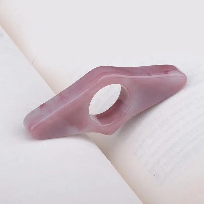 Acrylic thumb book page holder with geometric design, supporting pages for easy reading and convenient book access.