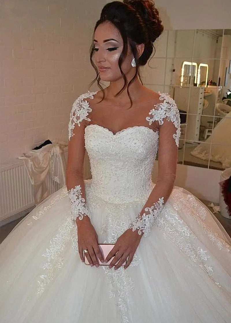 Elegant long sleeve tulle wedding gown by Showlu Fashion with a ball gown silhouette, perfect for a romantic bridal look.