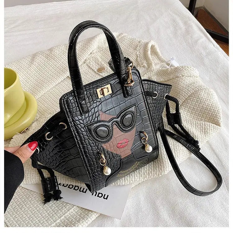 Showlu Women's black crocodile pattern foldable crossbody handbag with face design and spacious interior.