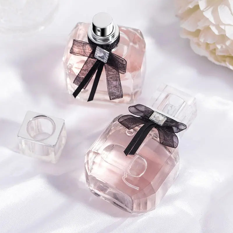 Luxury women's perfume by Showlu Fashion Store in a clear glass bottle, showcasing elegant fragrance packaging.