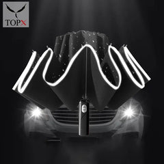 A black, fully automatic, three-folding umbrella with a reflective stripe, displayed against a car background.