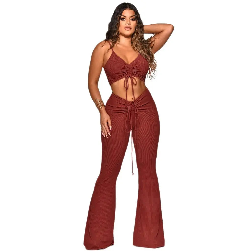 Women’s two-piece summer outfit by Showlu Fashion, featuring a nylon tank top and matching long pants, worn by a model outdoors.