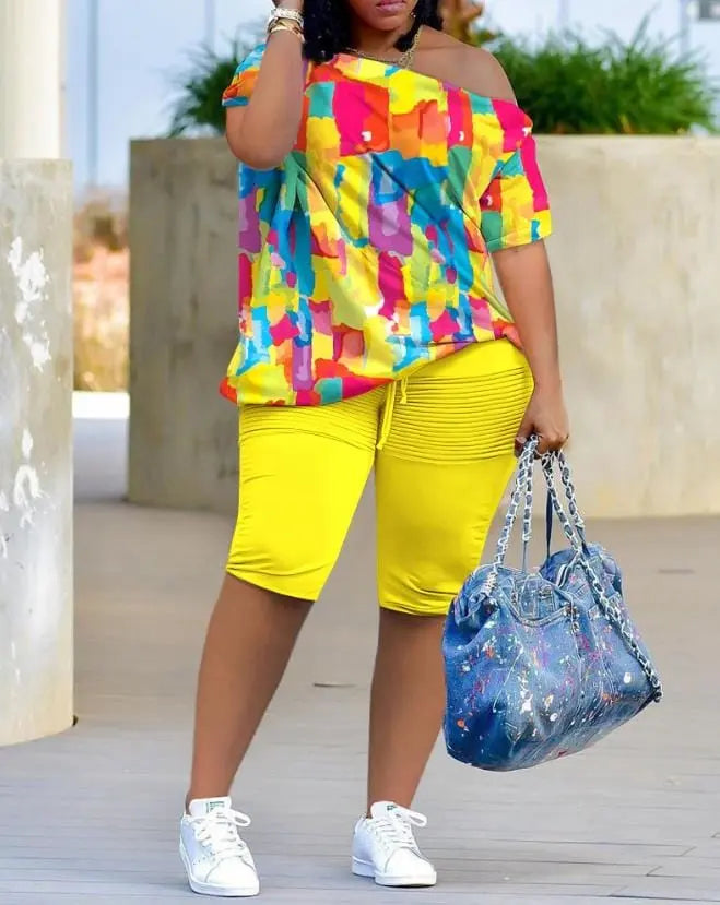 Women's two-piece shorts set by Anel Demosthene with melting colors print, featuring a skew neck top and matching shorts for summer.