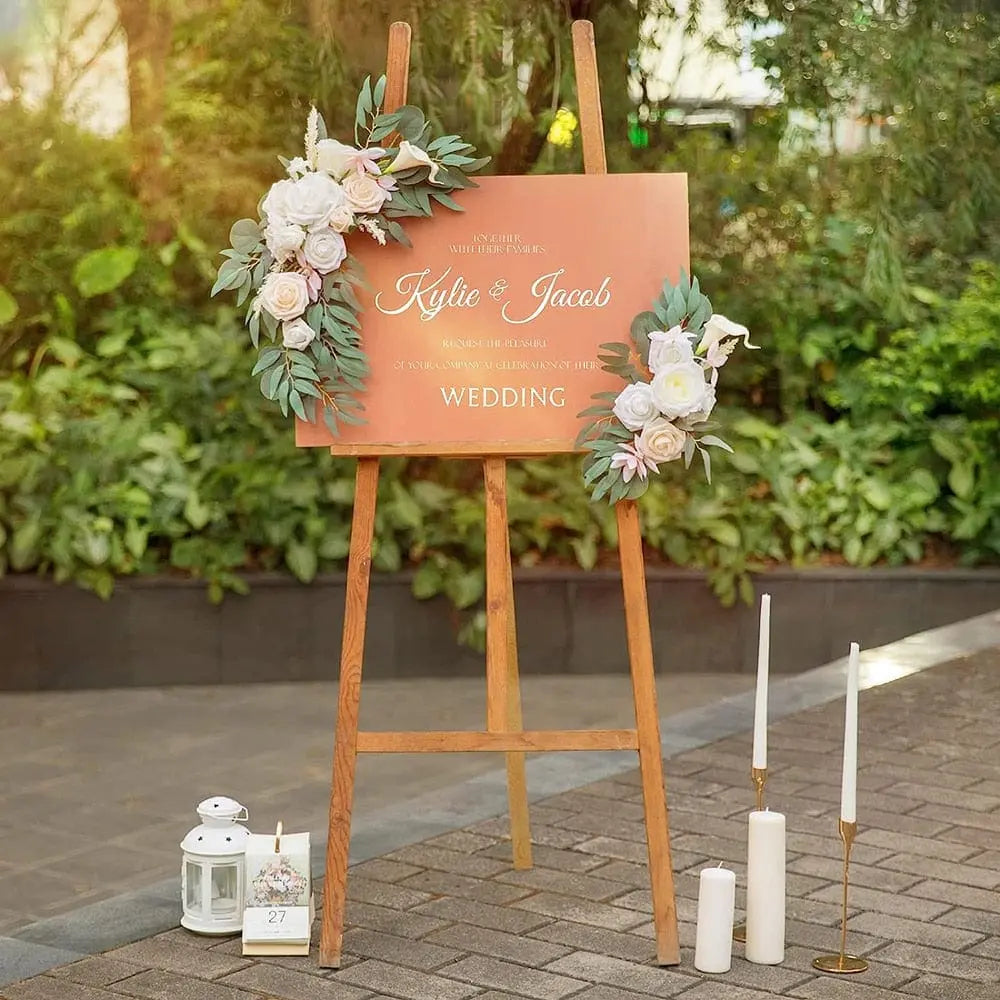 Artificial wedding arch flowers kit with dusty rose silk garland, eucalyptus accents, drapes, and welcome sign for wedding decor.