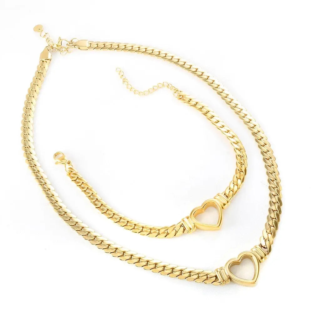 Gold-plated stainless steel heart necklace and nail bracelet set featuring a luxury love heart chain and bracelet for women.