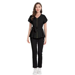A woman wears a black medical scrub set featuring a zippered peplum top with a tie waist.