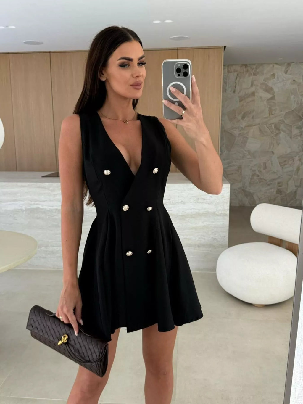 Double-breasted V-neck mini dress by Trendsi featuring long sleeves and a fitted silhouette, shown on a model.