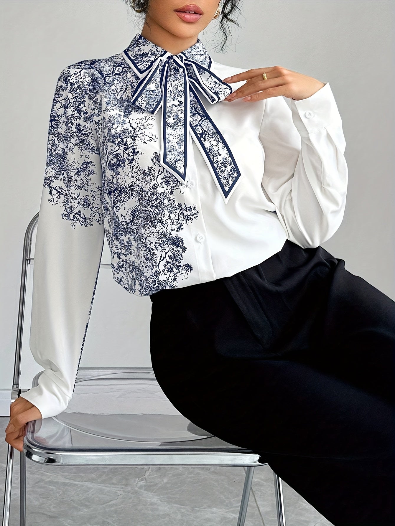 SHOWLU Women's floral bow tie blouse with semi-sheer long sleeves, featuring a stylish bow detail and delicate floral pattern.