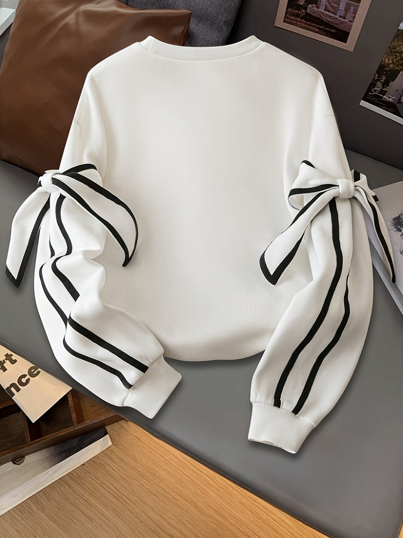 White ruffled sleeve women's sweatshirt by SHOWLU FASHION STORE, casual knit pullover with stylish ruffle details on sleeves.