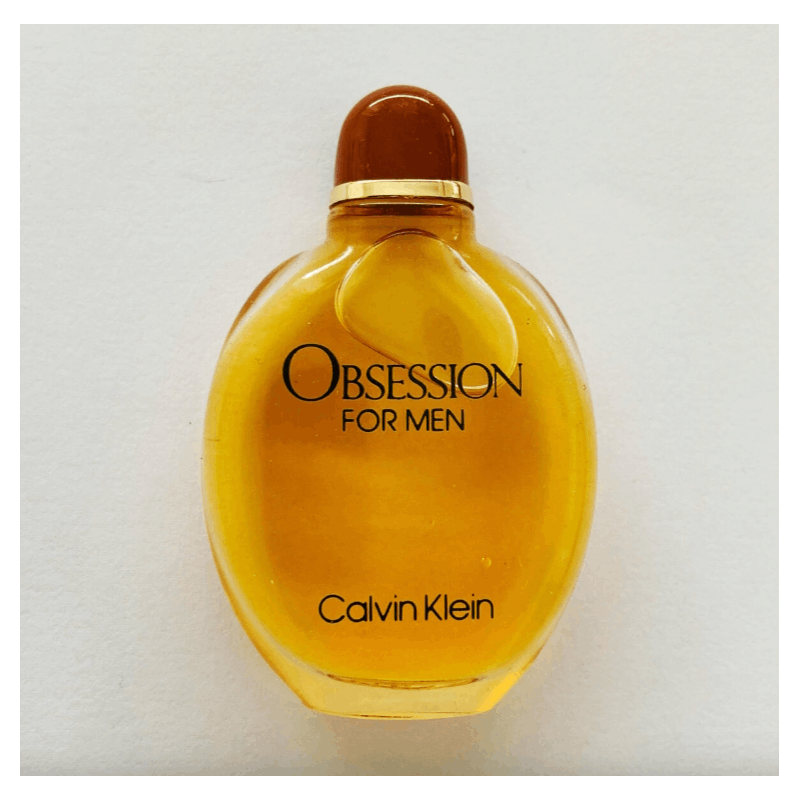 Calvin Klein Obsession for Men Oriental Woody EDT spray bottle with black cap and label, displayed on a neutral background.