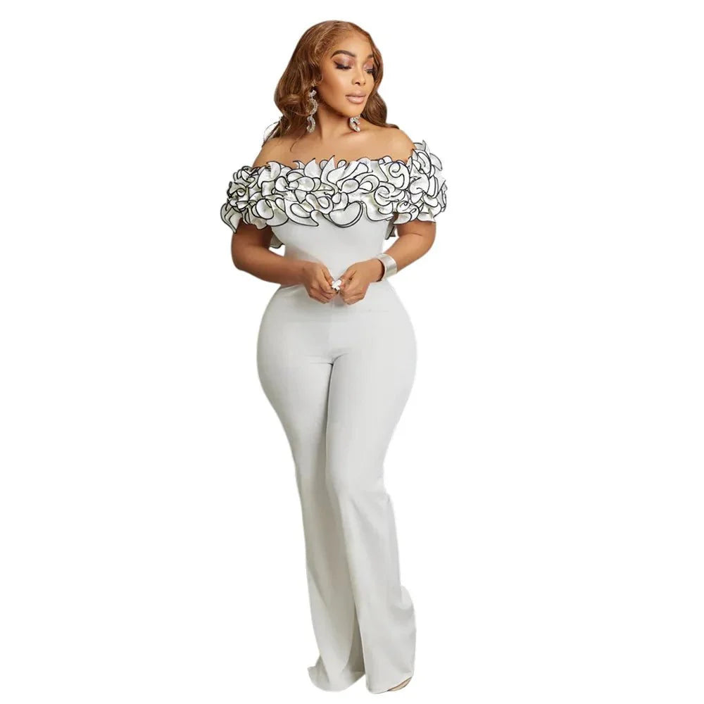 Woman wearing a black and white African dashiki long jumpsuit, elegant polyester partywear for women.