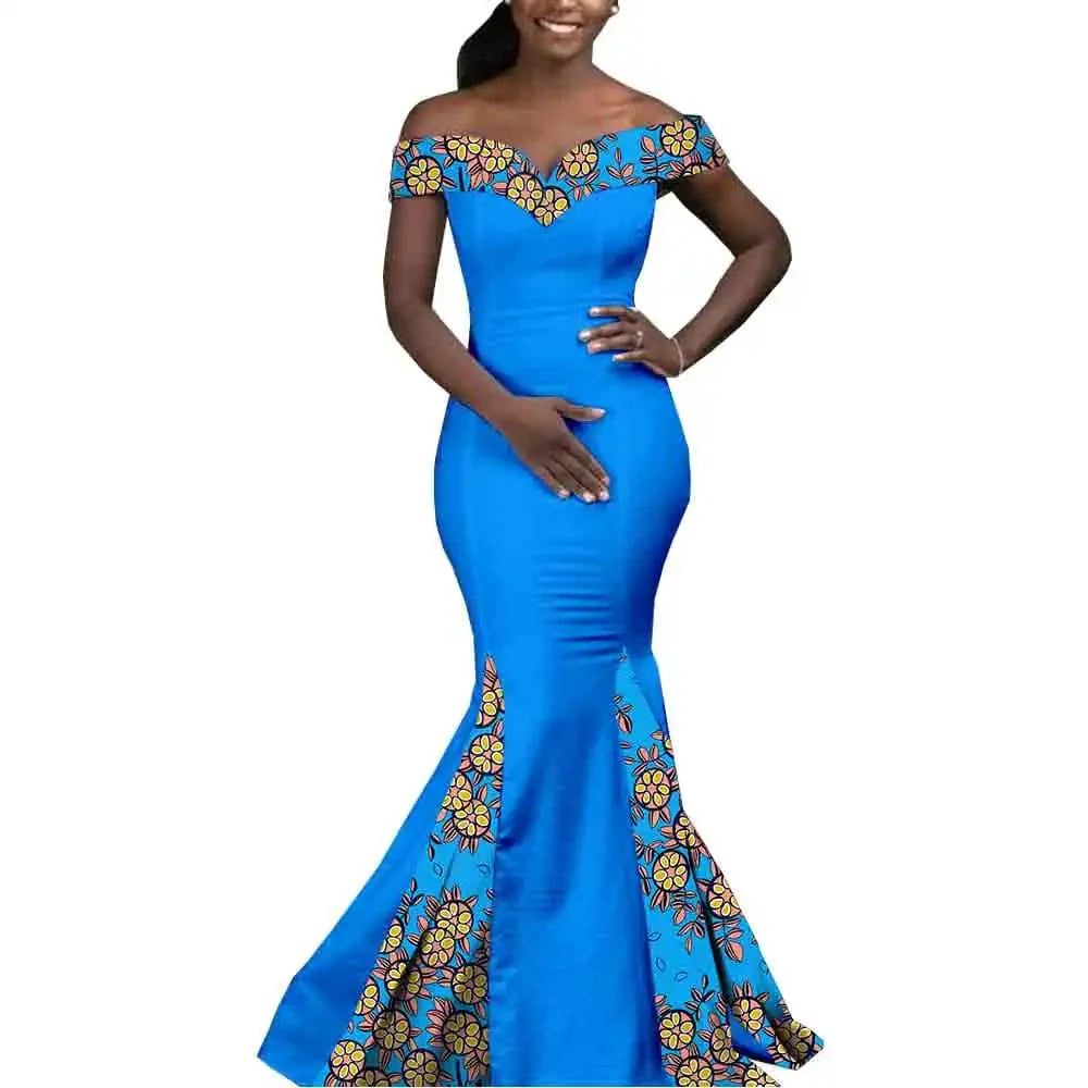 African couple matching outfits by SHOWLU FASHION STORE, featuring a woman in a mermaid dress and a man in a 3-piece set with hat.