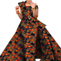 A woman wears an off-the-shoulder floor-length dress featuring a vibrant orange and black print.