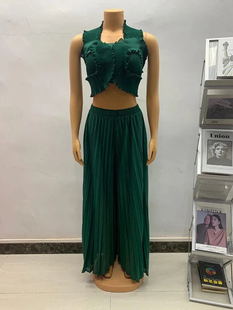 Anlan Miyake pleated 2-piece set featuring a sexy halter crop top and wide-leg pants in solid fabric with ruffle details.