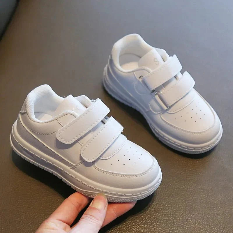 Kids white sneakers by Showlu Fashion Store featuring breathable, non-slip sport shoes with soft soles for boys and girls.