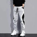Men's loose patchwork harem pants featuring casual ankle-length design, breathable fabric, and elastic waist for comfortable wear.