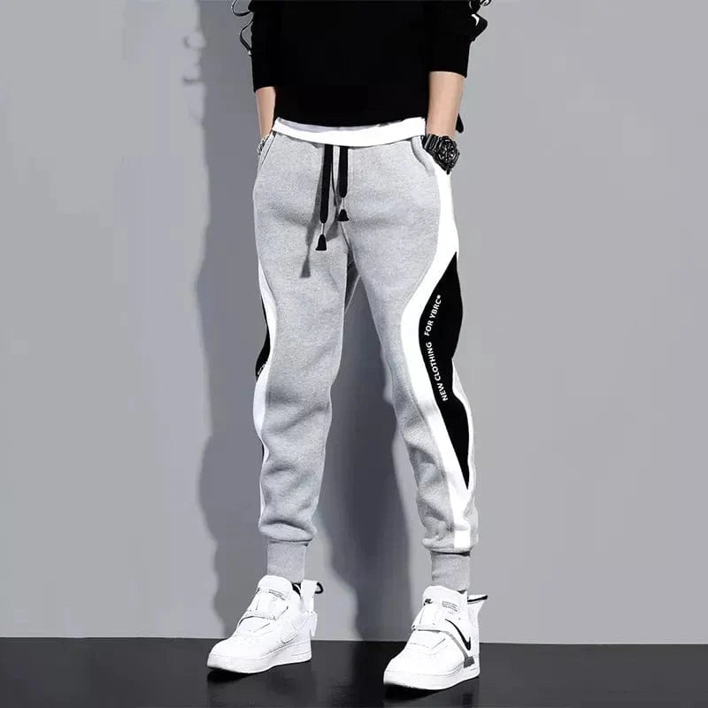 Men's loose patchwork harem pants featuring casual ankle-length design, breathable fabric, and elastic waist for comfortable wear.
