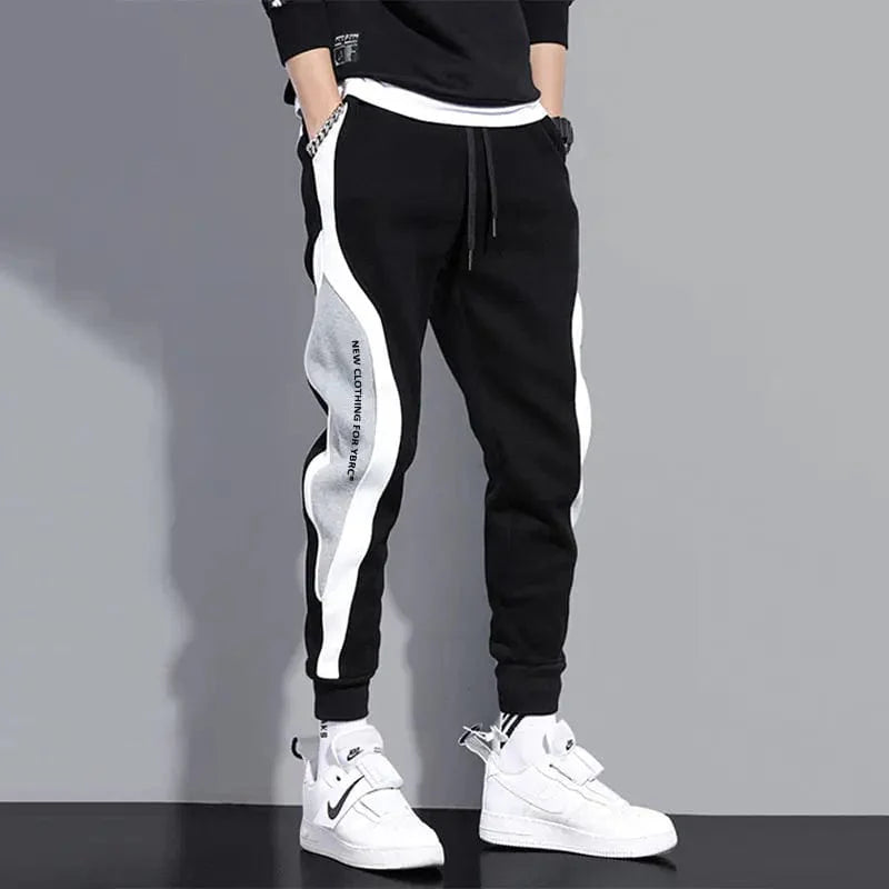 Men's loose patchwork harem pants with wide, breathable fabric, elastic waistband, and ankle-length design for casual style.