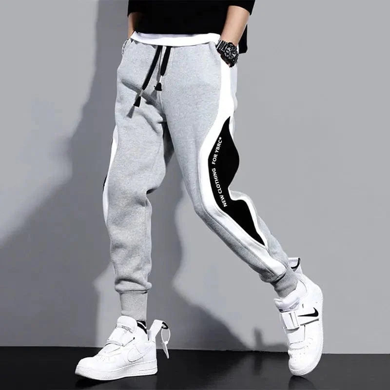 Men's loose patchwork harem pants with ankle-length design, elastic waist, breathable fabric, and casual style.