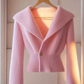 Pink dopamine knit cardigan with V-neck and long sleeves by SHOWLU FASHION, styled as a cozy, fashionable top.