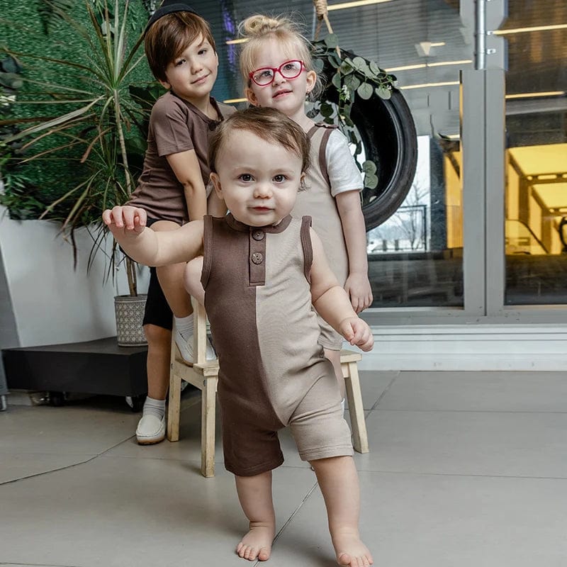 Baby boy sleeveless colorblock denim romper with front buttons, round neck, and short overalls for summer wear.