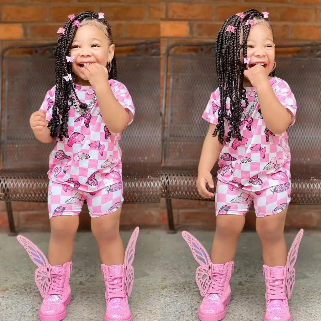 Cute girls' summer clothing set with short sleeve rainbow top and matching colorful shorts, suitable for children around 8 years old.
