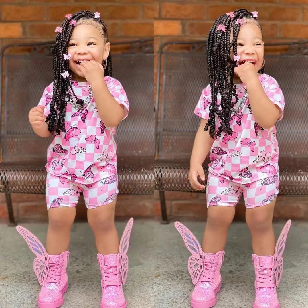 Cute girls' summer clothing set with short sleeve rainbow top and matching colorful shorts, suitable for children around 8 years old.