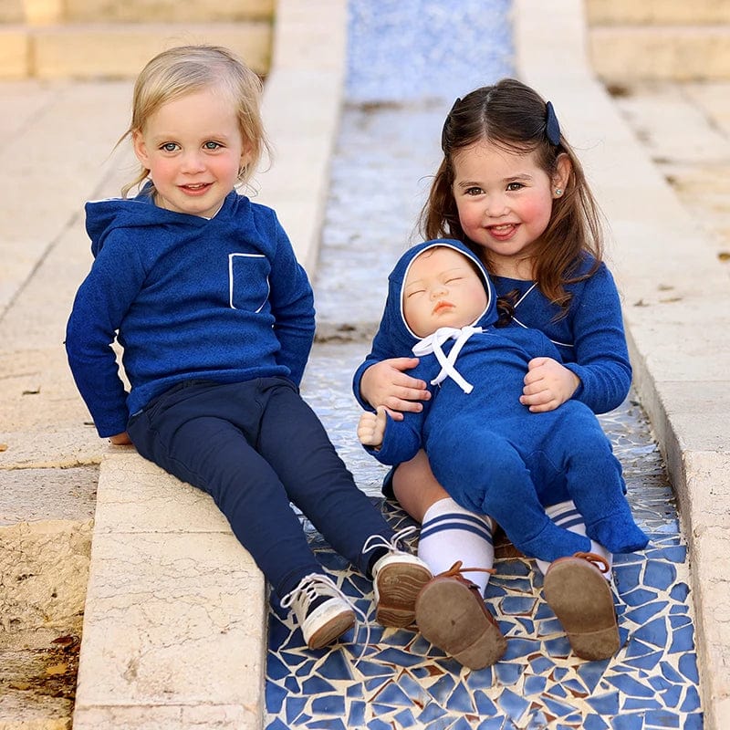 Baby girl wearing Bloom Baby long sleeve rib cotton footie romper and matching hat set for autumn winter, showing cozy, soft fabric.
