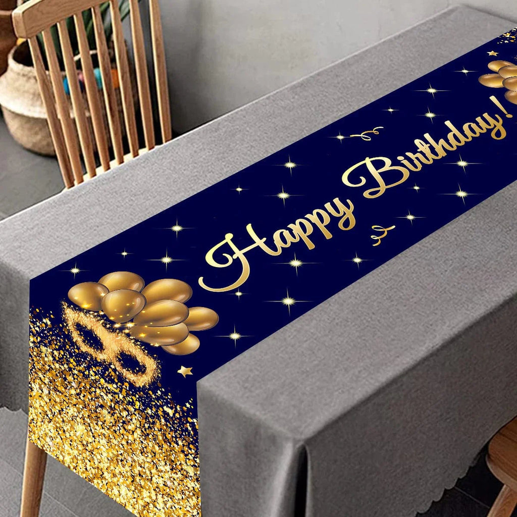 Black and gold Showlu birthday table runner, polyester party decor for kids and adults, festive home or event table decoration.
