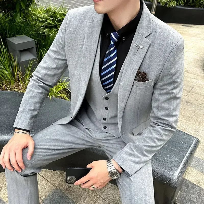 Elegant men's 3-piece slim fit business suit with blazer, vest, and trousers in black, tailored for formal and casual occasions.