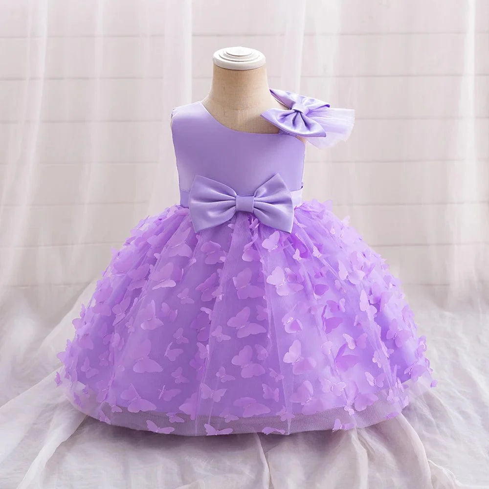 White butterfly tulle baptism and wedding gown for baby girls, featuring a bow, floral details, perfect for special occasions.