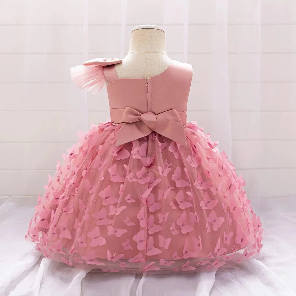White butterfly tulle baptism and wedding gown for baby girls, featuring a bow, floral accents, and a princess-style tutu design.