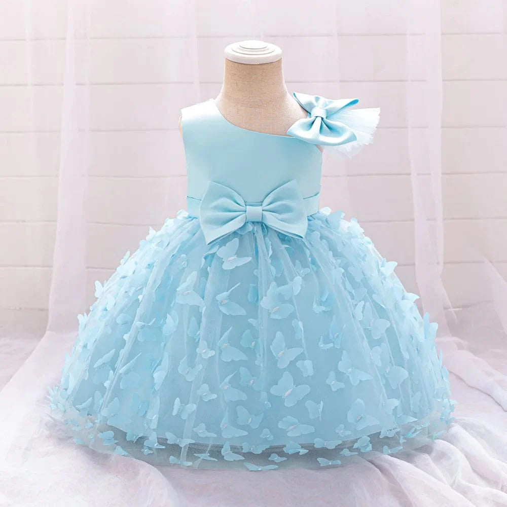 White butterfly tulle baptism and wedding gown for baby girls, featuring a bow, floral accents, and princess-style tulle design.