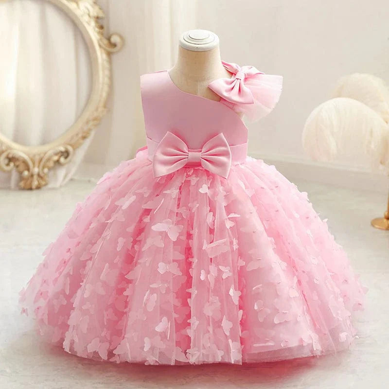 White butterfly tulle baptism and wedding gown for baby girls, with floral accents and a bow, perfect for special occasions and first celebrations.