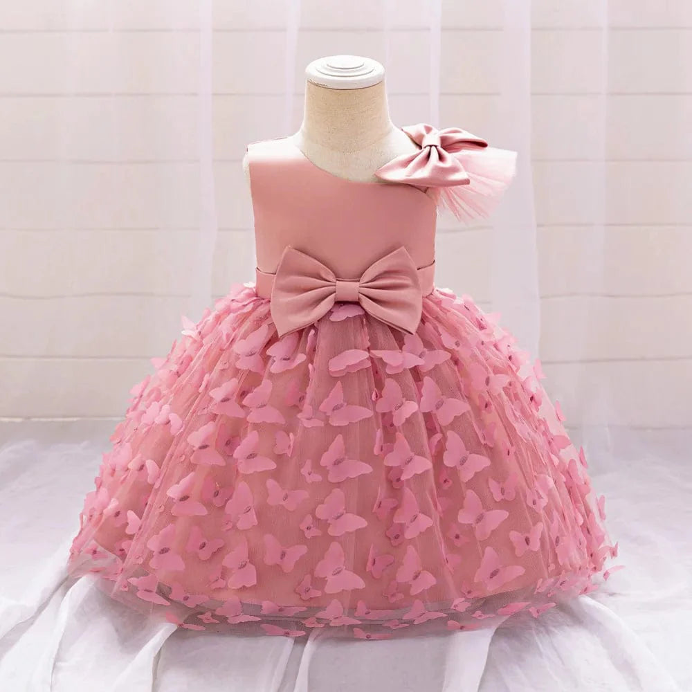 Miqiaikids white butterfly tulle baptism and wedding gown for baby girls, featuring a bow, floral details, and a tutu skirt.