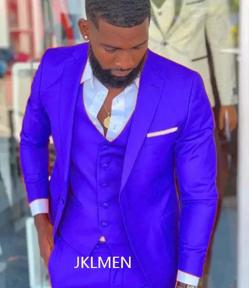 Bright orange slim fit men's 3-piece suit with notch lapel, shown on a mannequin for wedding or prom occasions.