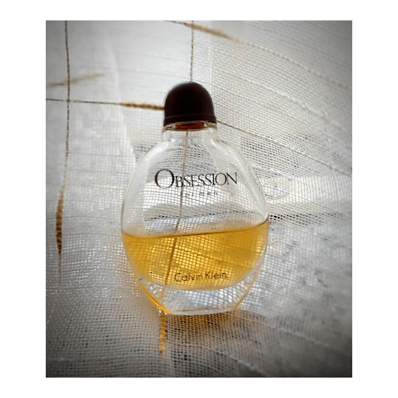 Calvin Klein Obsession for Men Oriental Woody EDT cologne bottle with black cap and gold accents.