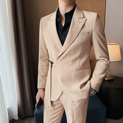 A man wears a slim-fit beige suit jacket featuring a side buckle closure and a black shirt.