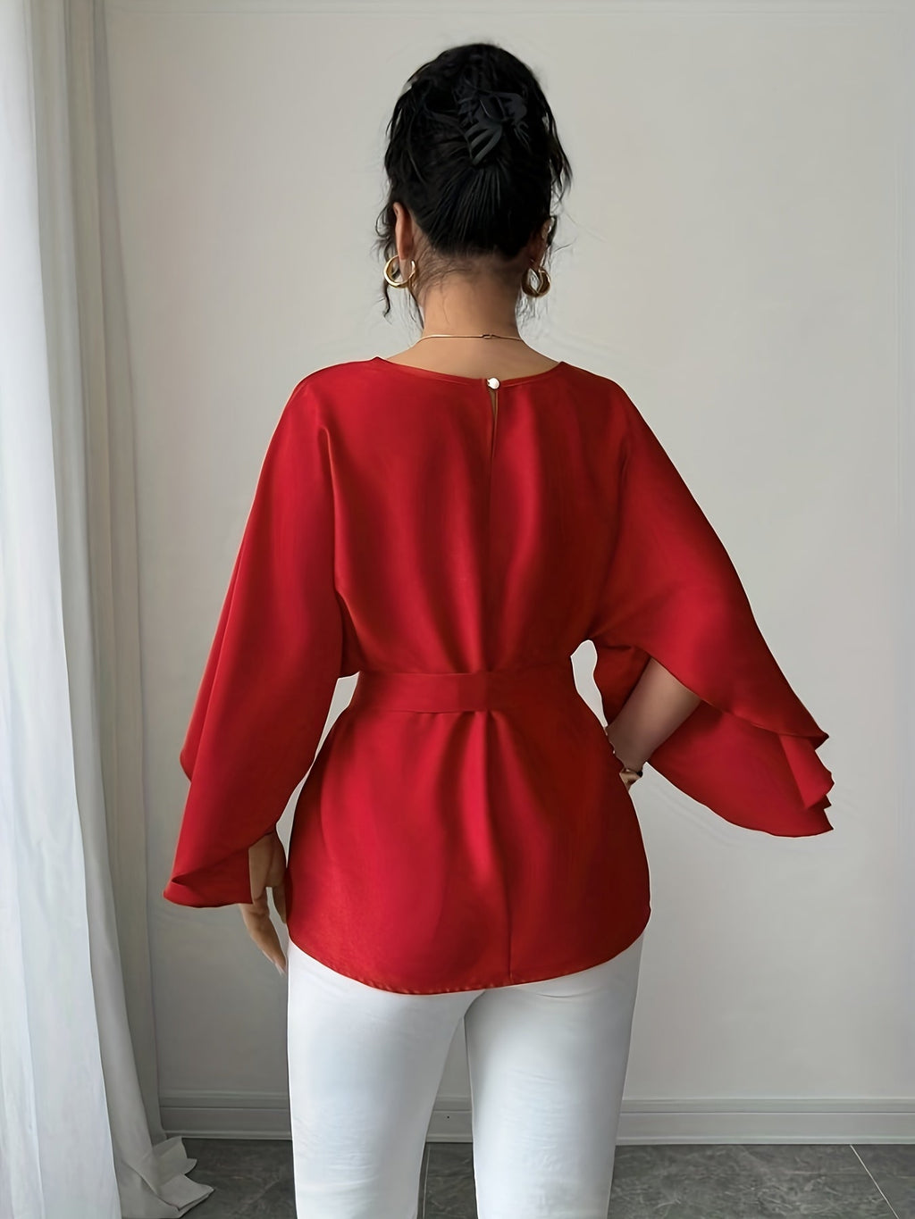 Light blue SHOWLU FASHION long sleeve belted blouse with crew neck, elegant and stylish, displayed on a hanger against a neutral background.